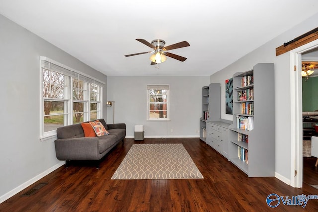 unfurnished living room with baseboards, wood finished floors, visible vents, and ceiling fan