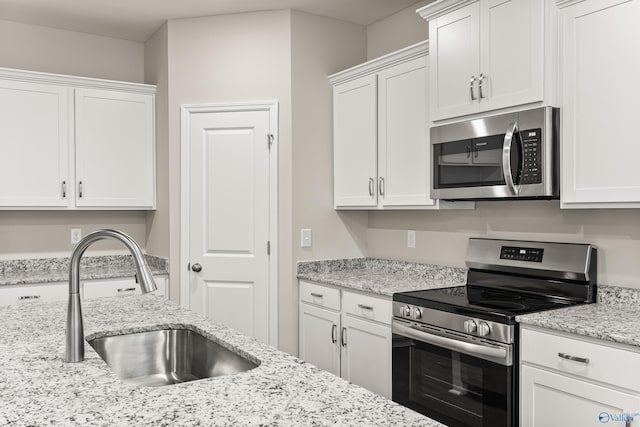 34 Aurora Cir, Fayetteville, TN 37334 - kitchen featuring appliances with stainless steel finishes, a sink, white cabinets, and light stone countertops