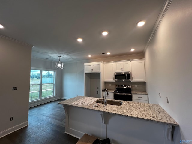 kitchen with appliances with stainless steel finishes, white cabinetry, dark wood-type flooring, a kitchen bar, and sink