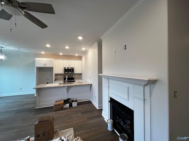 living room with crown molding, ceiling fan, dark wood-type flooring, and sink