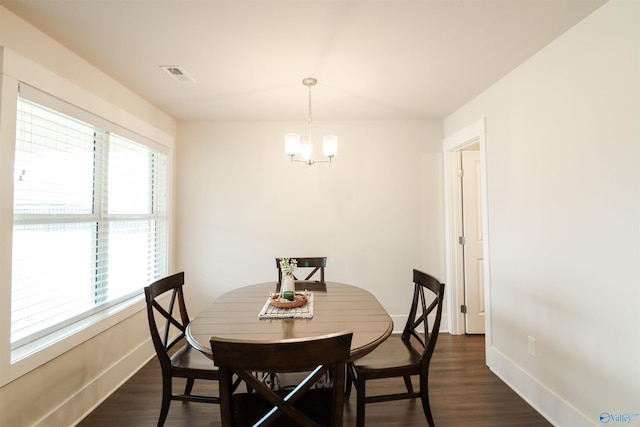 dining room with a chandelier and dark hardwood / wood-style flooring