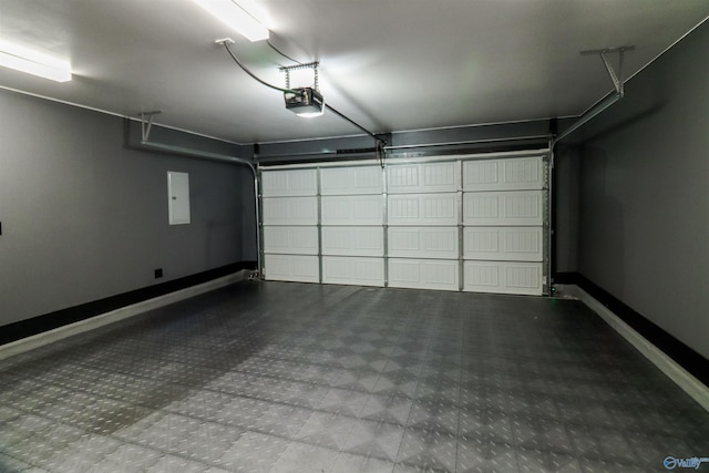 garage featuring electric panel and a garage door opener