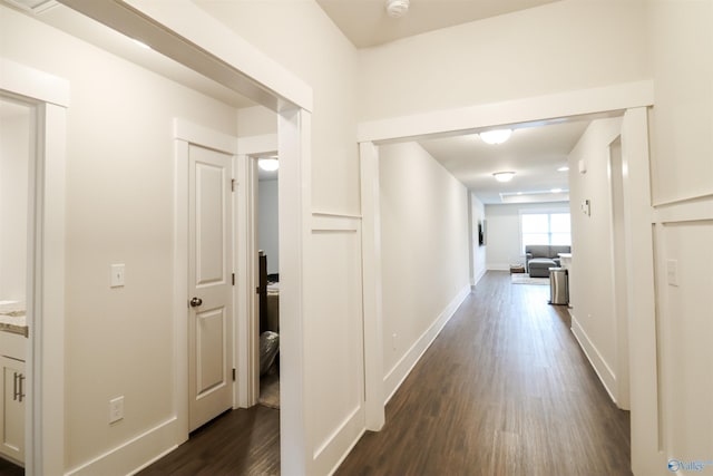 hall with dark wood-type flooring