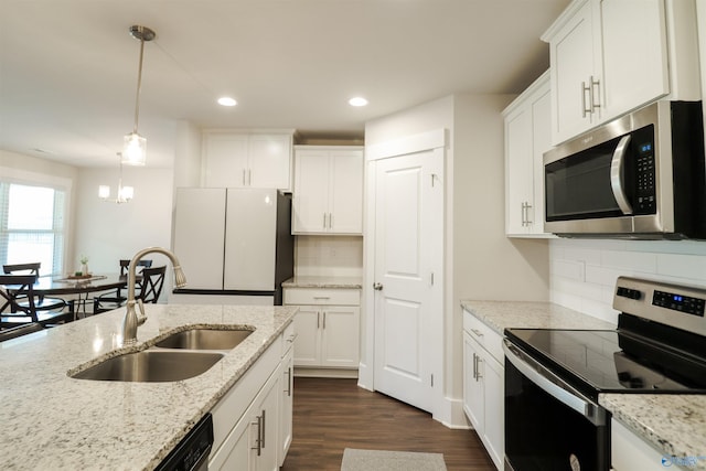 kitchen featuring decorative backsplash, appliances with stainless steel finishes, decorative light fixtures, and sink