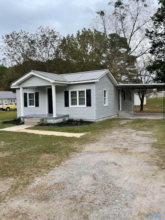 ranch-style home with a front lawn and a carport