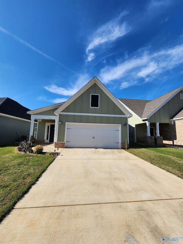 ranch-style home featuring a front lawn and a garage