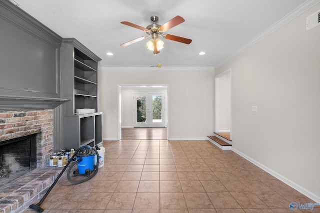 living area with ornamental molding, a brick fireplace, visible vents, and baseboards