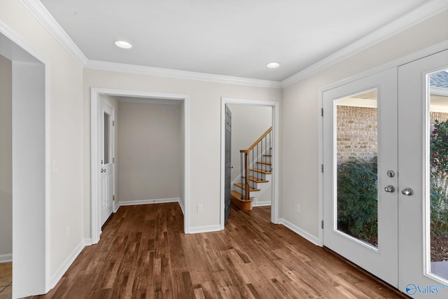 interior space featuring baseboards, ornamental molding, dark wood finished floors, and french doors