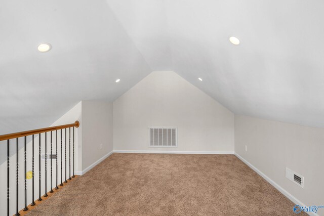 bonus room featuring carpet floors, visible vents, vaulted ceiling, and baseboards