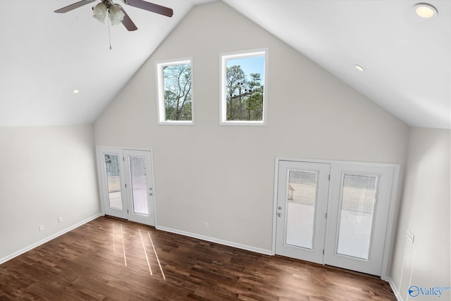unfurnished living room featuring dark wood-style floors, high vaulted ceiling, baseboards, and a ceiling fan