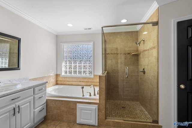bathroom with vanity, visible vents, ornamental molding, a bath, and a stall shower