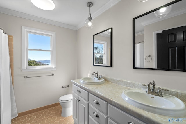 bathroom featuring tile patterned flooring, crown molding, baseboards, and a sink