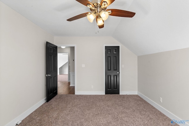 unfurnished bedroom with vaulted ceiling, carpet floors, ceiling fan, and baseboards