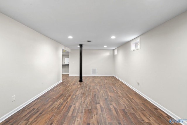 below grade area with recessed lighting, visible vents, dark wood finished floors, and baseboards