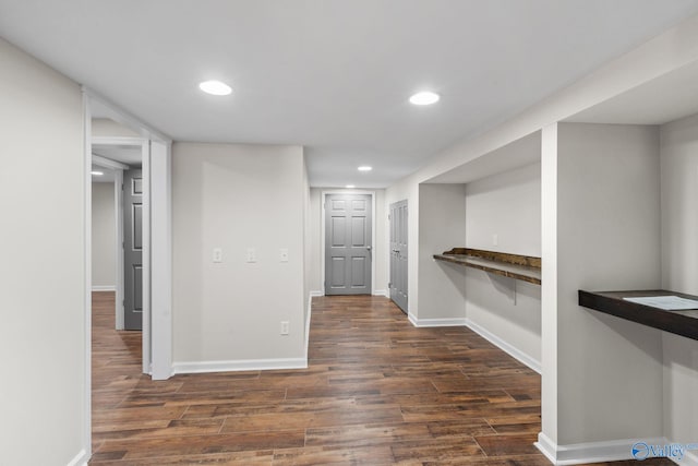 interior space featuring baseboards, dark wood-style flooring, and recessed lighting