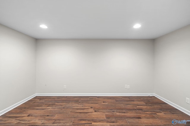 empty room featuring dark wood-type flooring, recessed lighting, and baseboards