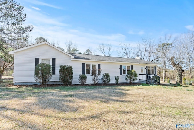 single story home with a chimney and a front lawn