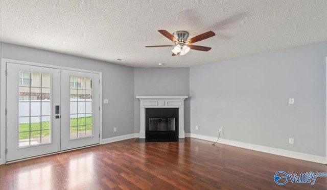 unfurnished living room featuring dark hardwood / wood-style floors, ceiling fan, a textured ceiling, and french doors