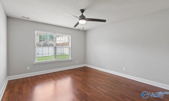 unfurnished room featuring ceiling fan, dark hardwood / wood-style flooring, and a textured ceiling