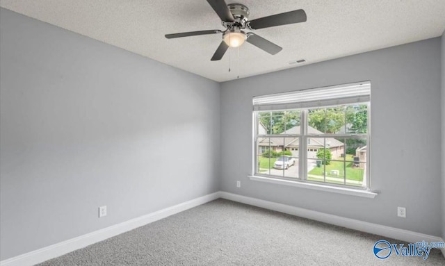 empty room featuring ceiling fan, carpet floors, and a textured ceiling