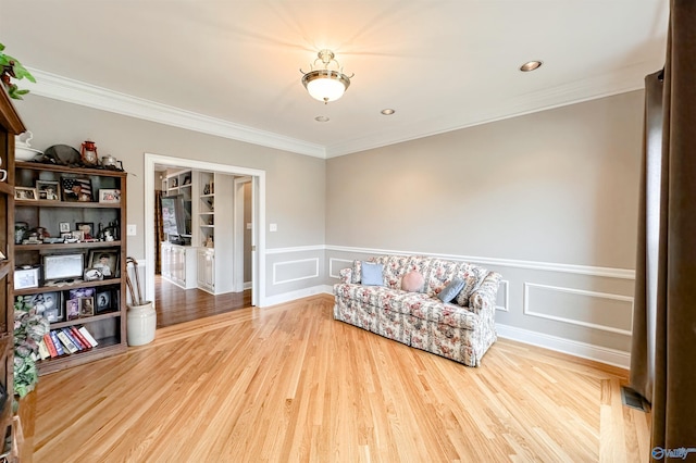 904 Whispering Pines Trl, Decatur, AL 35603 - living area with crown molding, wood finished floors, wainscoting, and a decorative wall
