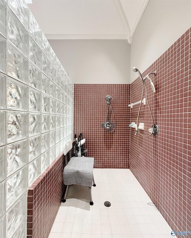 904 Whispering Pines Trl, Decatur, AL 35603 - bathroom with ornamental molding, a tile shower, tile walls, and tile patterned floors