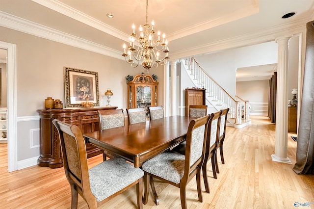 904 Whispering Pines Trl, Decatur, AL 35603 - dining space with stairs, light wood-style flooring, a decorative wall, crown molding, and a tray ceiling