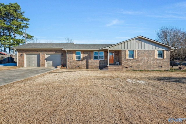 ranch-style home featuring driveway, crawl space, an attached garage, board and batten siding, and brick siding