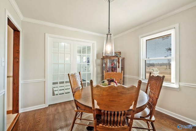 dining room with baseboards, dark wood-style flooring, and crown molding