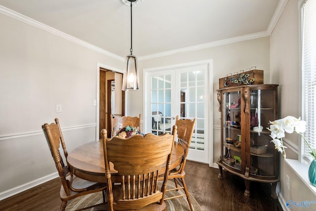 dining room with crown molding, baseboards, dark wood-type flooring, and french doors