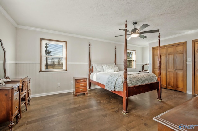 bedroom featuring a textured ceiling, ornamental molding, and dark wood finished floors