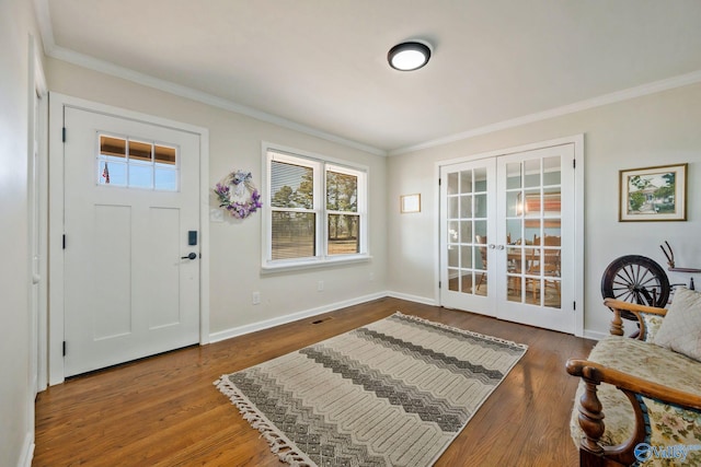 entryway with ornamental molding, french doors, and wood finished floors