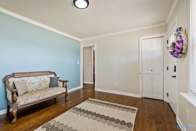 sitting room featuring dark wood-style floors, baseboards, and ornamental molding