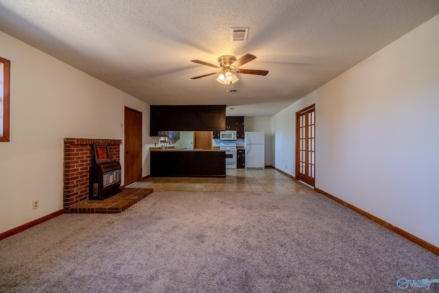 unfurnished living room featuring light carpet, visible vents, baseboards, and a ceiling fan