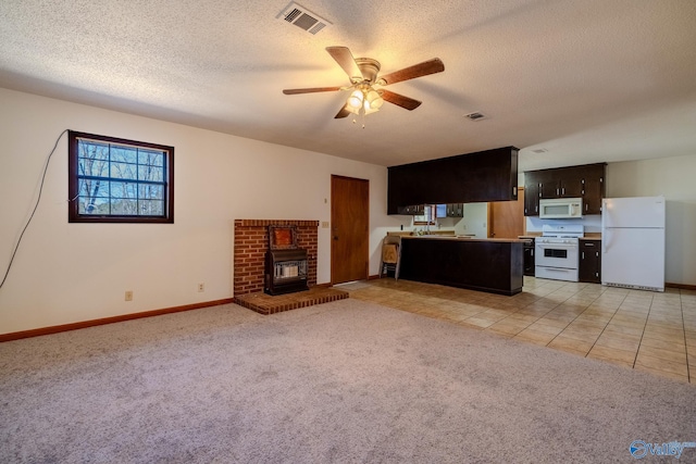 unfurnished living room featuring a ceiling fan, baseboards, visible vents, a textured ceiling, and light carpet