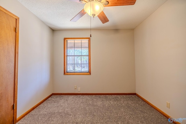 empty room featuring baseboards, carpet, a ceiling fan, and a textured ceiling