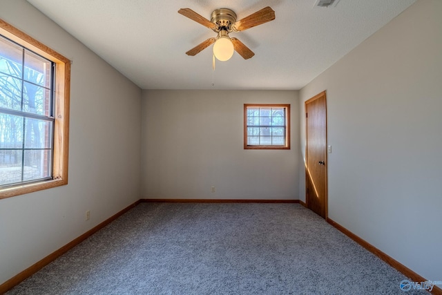 unfurnished room featuring visible vents, a ceiling fan, baseboards, and carpet floors