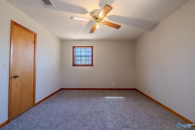 unfurnished room featuring visible vents, baseboards, ceiling fan, carpet floors, and a textured ceiling