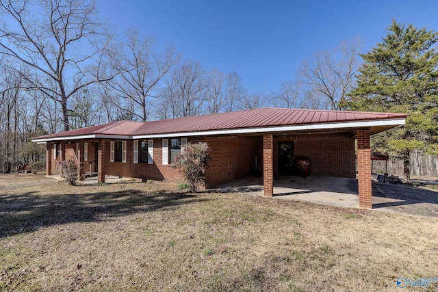 exterior space featuring a carport, a lawn, brick siding, and metal roof