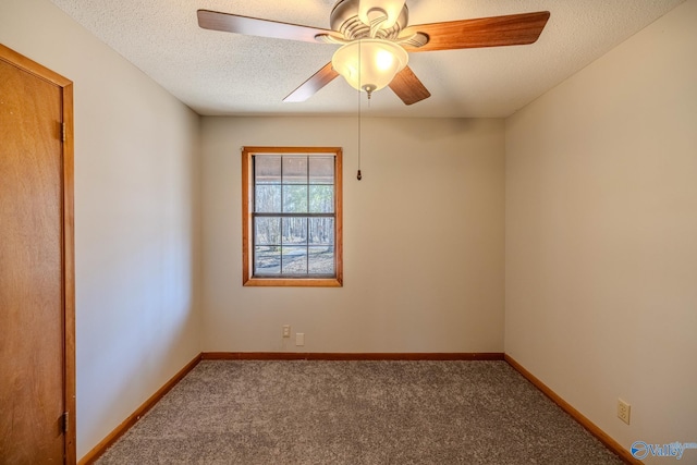 carpeted spare room with baseboards, a textured ceiling, and ceiling fan