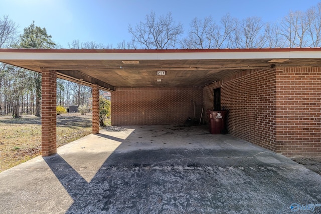 view of parking featuring an attached carport and driveway