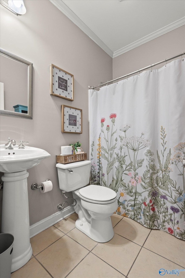 bathroom featuring tile patterned flooring, sink, ornamental molding, and toilet