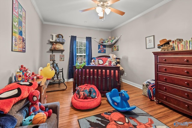 bedroom with ornamental molding, ceiling fan, and light hardwood / wood-style flooring