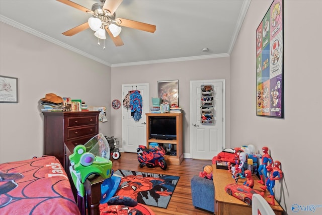 bedroom with ceiling fan, ornamental molding, and wood-type flooring