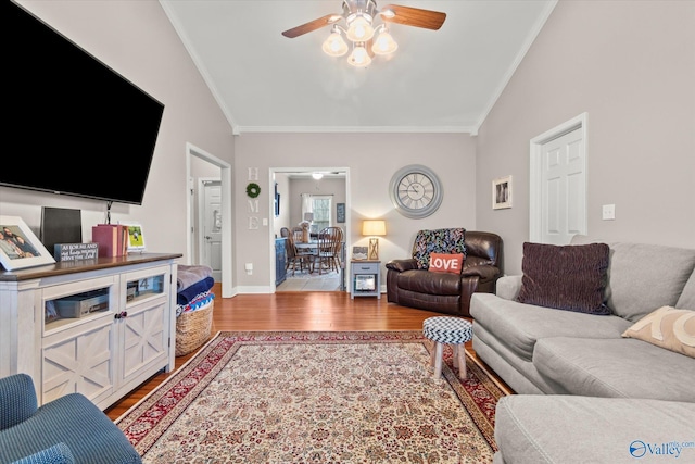 living room featuring crown molding, ceiling fan, vaulted ceiling, and hardwood / wood-style flooring