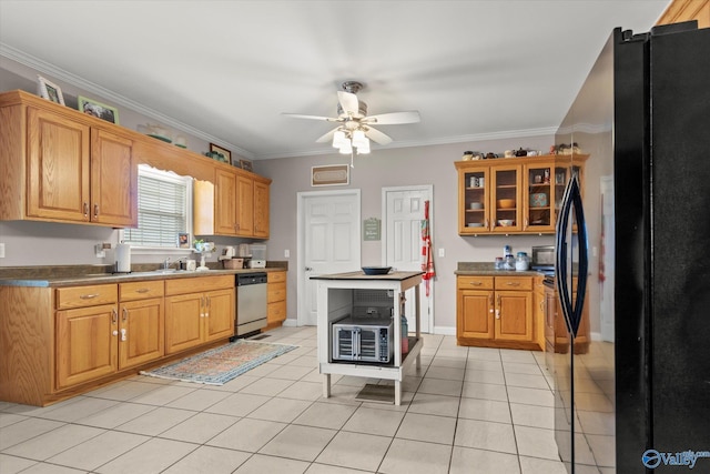 kitchen with black refrigerator, ornamental molding, stainless steel dishwasher, light tile patterned floors, and ceiling fan