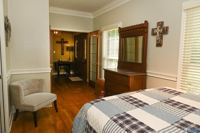 bedroom with dark hardwood / wood-style floors and crown molding