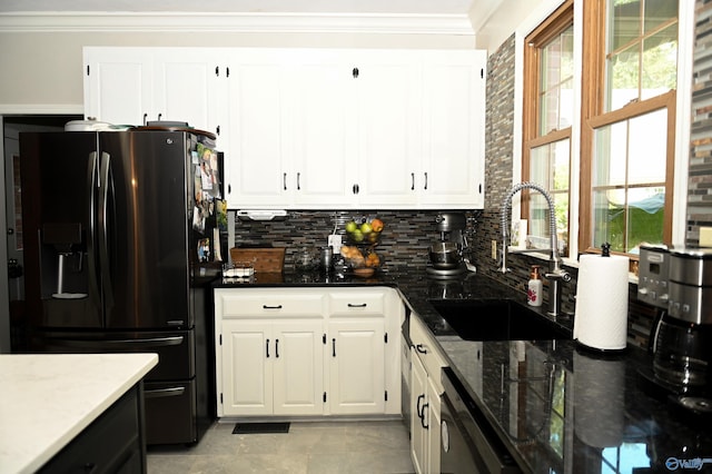 kitchen featuring light tile patterned flooring, black refrigerator with ice dispenser, sink, ornamental molding, and decorative backsplash