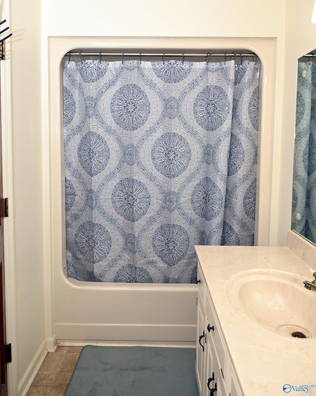 bathroom featuring tile patterned floors, vanity, and shower / bath combo with shower curtain