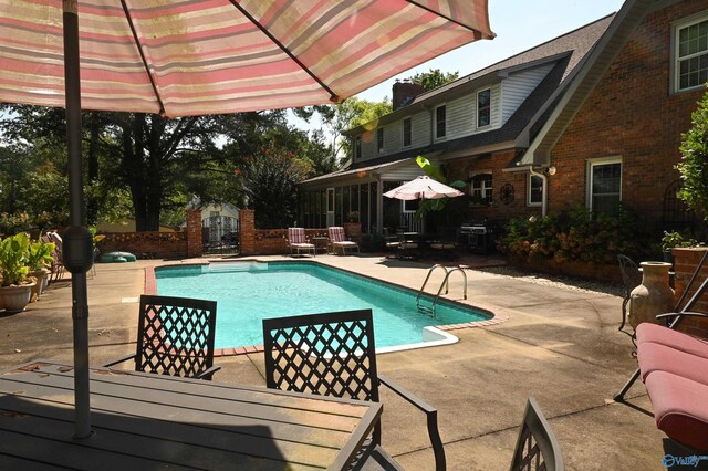 view of swimming pool featuring a patio area